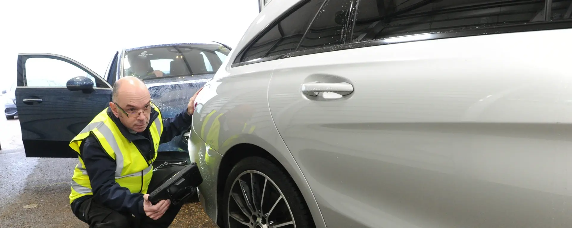 Man inspecting a car